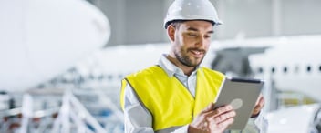 Building-worker-smiling-using-digital-tablet